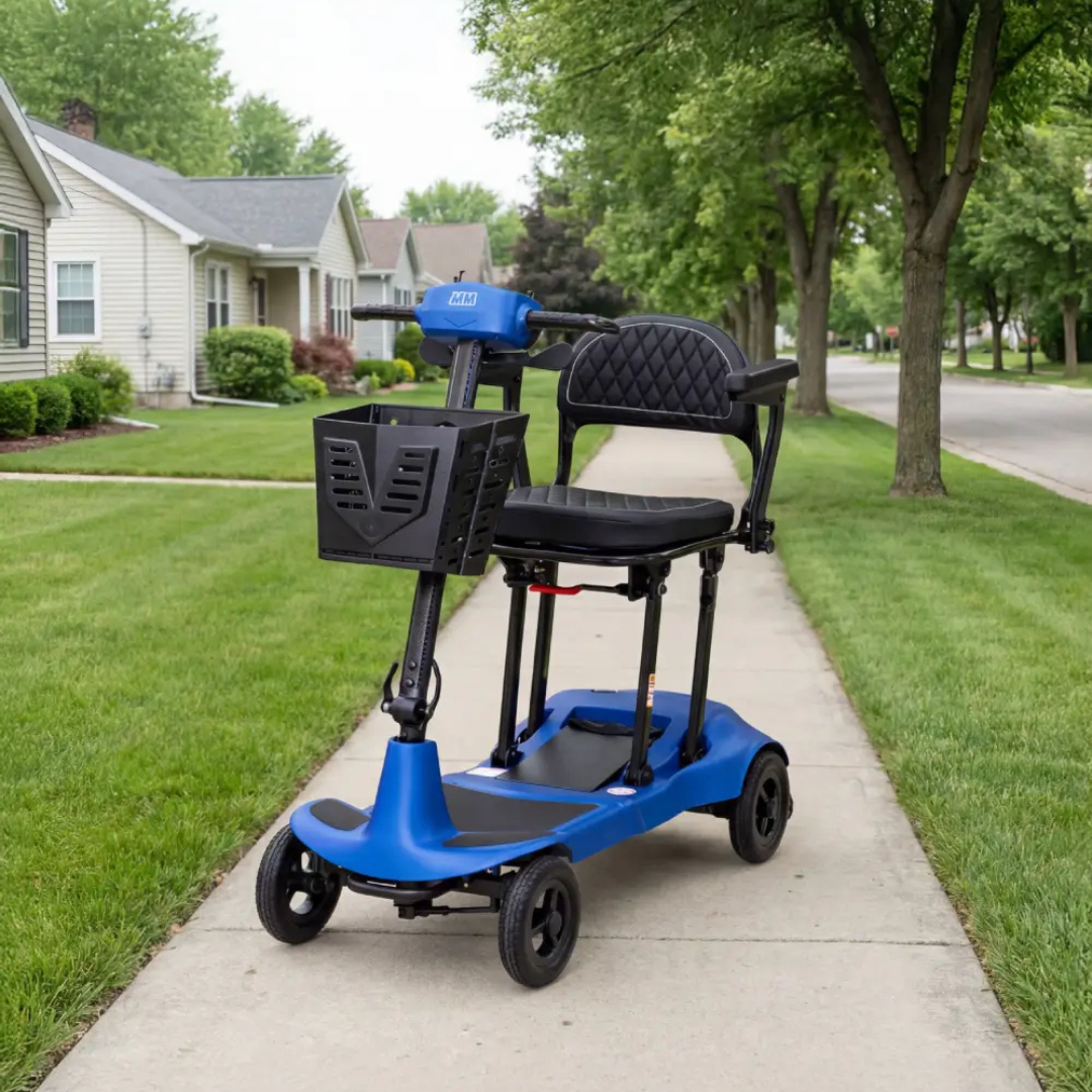 A Monarch Genie Ultralight Portable Mobility Scooter with a blue frame, black seat, and basket is parked on a suburban sidewalk surrounded by green lawns, trees, and houses; only CSS code appears in the product description.