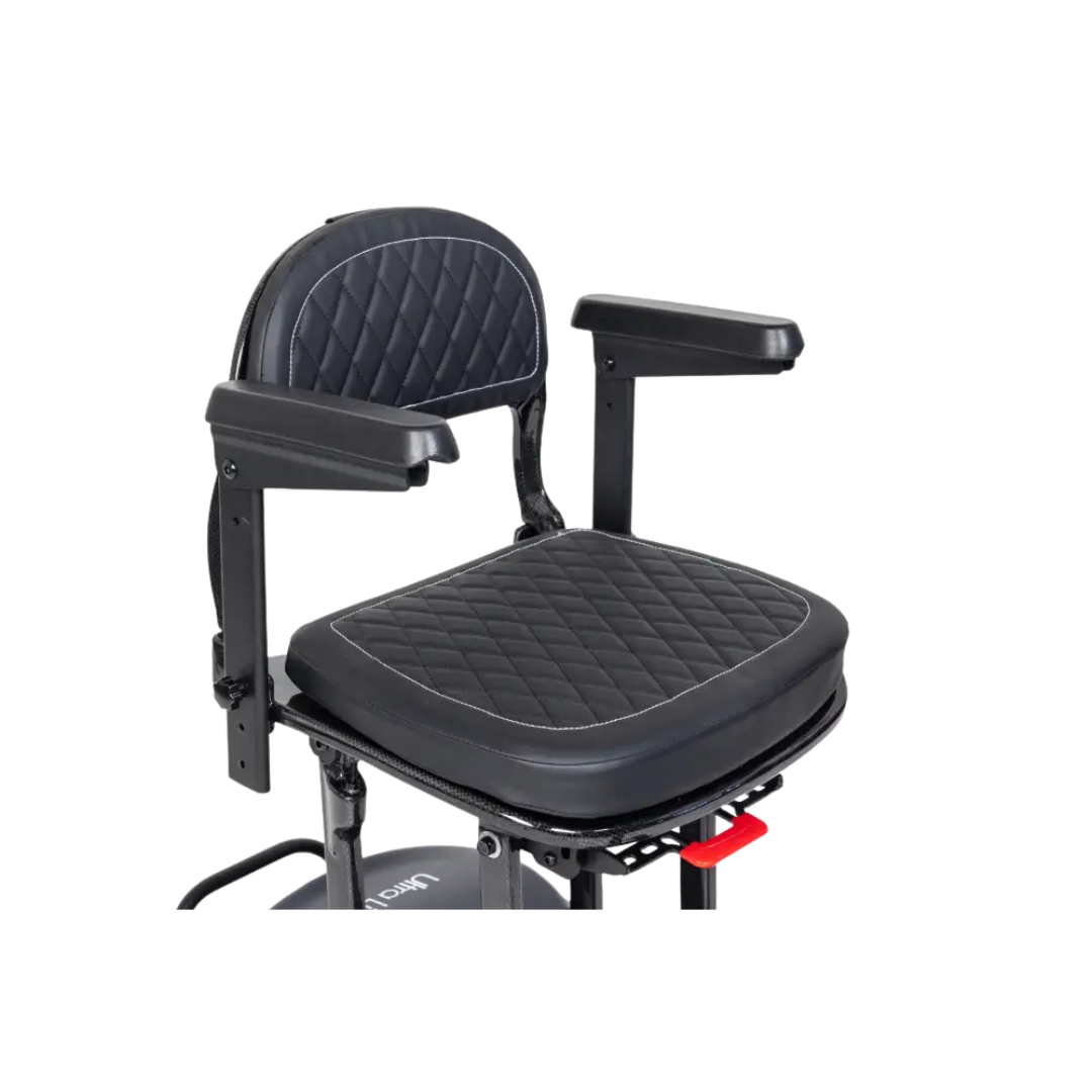 The Monarch Genie Ultralight Portable Mobility Scooter features a quilted black padded seat with matching raised armrests and diamond-stitched cushion, offering enhanced comfort and style for an improved mobility scooter experience.