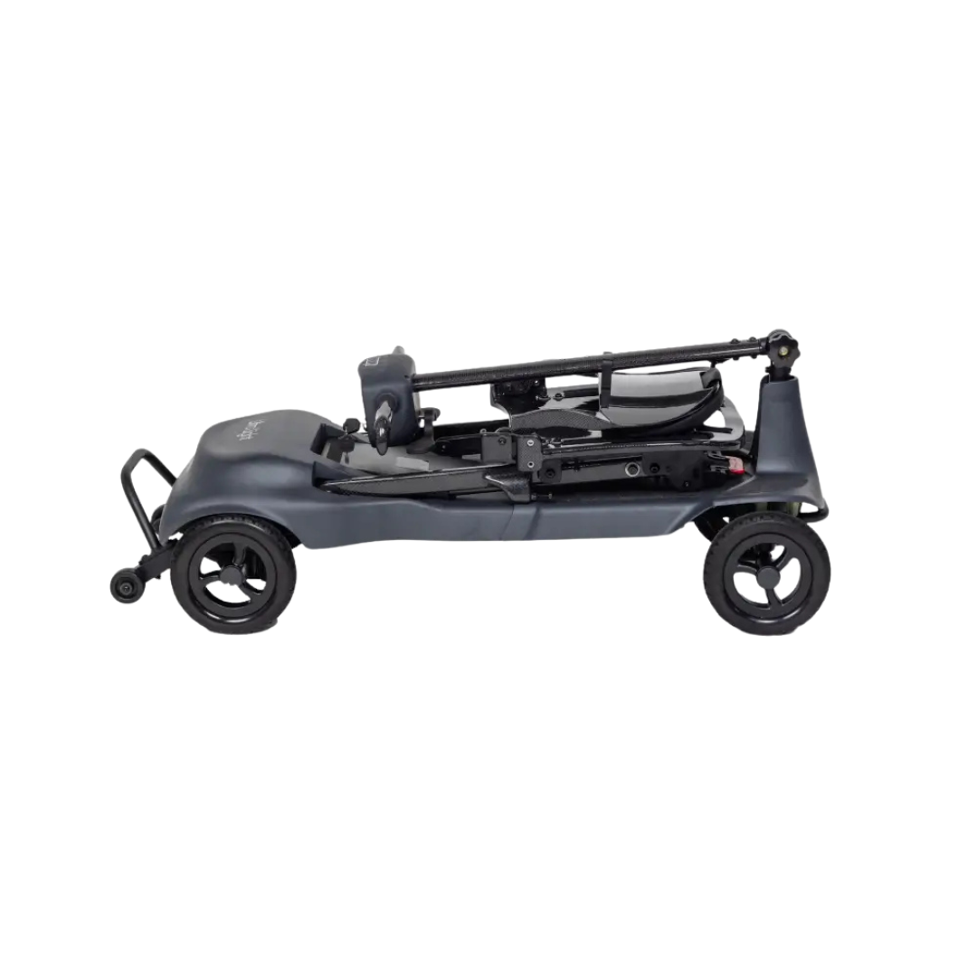 The Monarch Genie Ultralight Portable Mobility Scooter is a compact, black three-wheeled frame with minimal bodywork, shown partially folded from the side on a white background—designed for easy storage, transport, and convenient mobility.