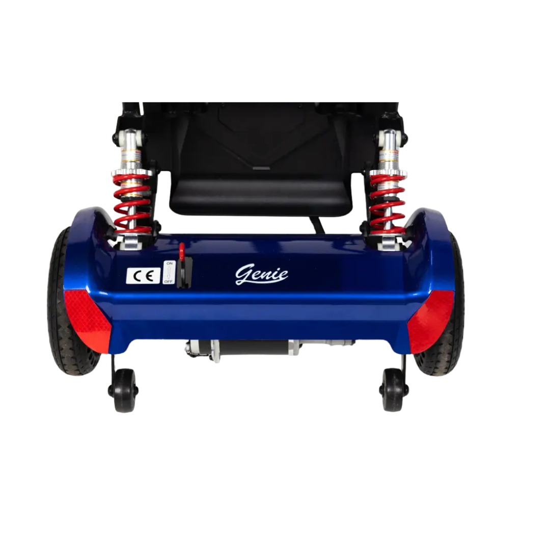 Rear view of the Monarch Genie Lightweight Portable Scooter in blue, featuring red suspension springs, two large rear wheels, anti-tip wheels, reflectors, and the underside of the seat visible above.