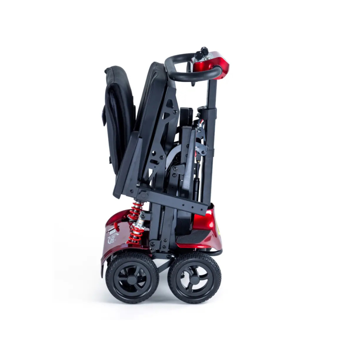 The Monarch Genie Lightweight Portable Scooter is shown folded upright with its seat and handle compacted, exposing the wheels and frame for easy transport or storage against a plain white background.