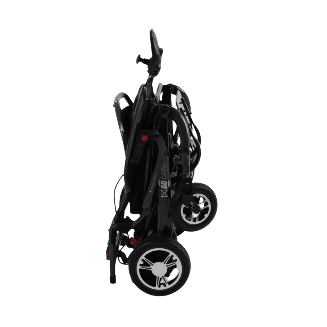 The Monarch MM60 Carbon Ultralite Electric Wheelchair is shown folded upright, highlighting its compact design with visible wheels and handle, all set against a white background.