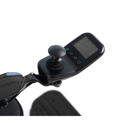 Close-up of the joystick controller, featuring a display screen and buttons, mounted on the black armrest of the Monarch MM60 Carbon Ultralite Electric Wheelchair.
