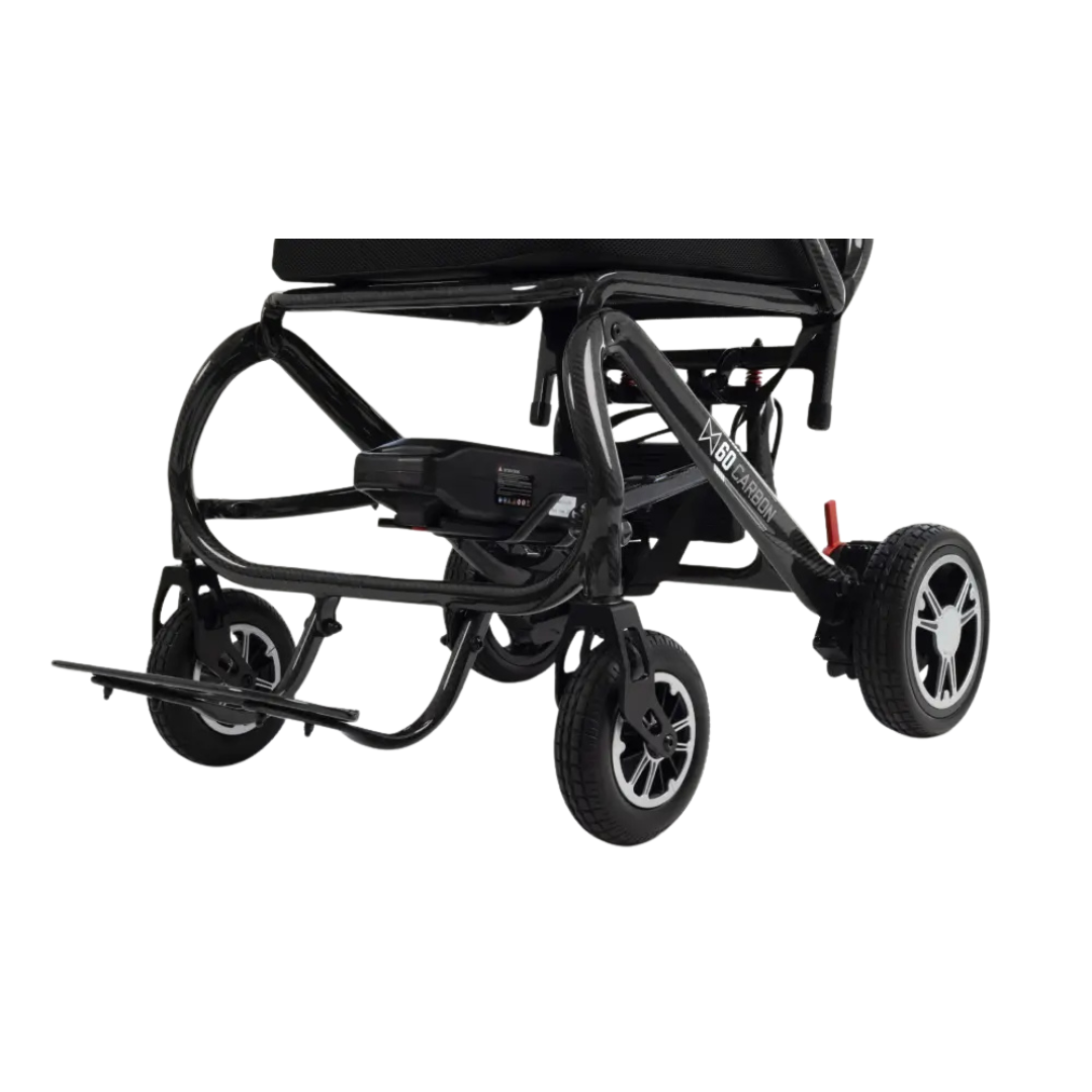 Close-up of the lower part of the Monarch MM60 Carbon Ultralite Electric Wheelchair, highlighting its wheels, footrest, and battery against a white background.