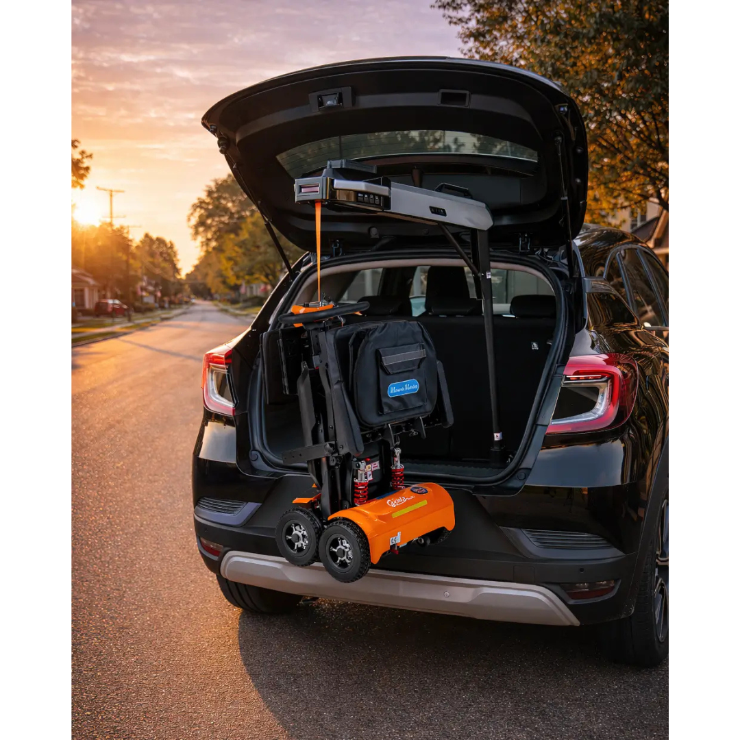 The Monarch Atlas 4 Portable Car Lift – Mobility Aid Lifter is shown folded and secured in the trunk of a black SUV on a suburban street at sunset, with the open trunk revealing its scooter lift mechanism.