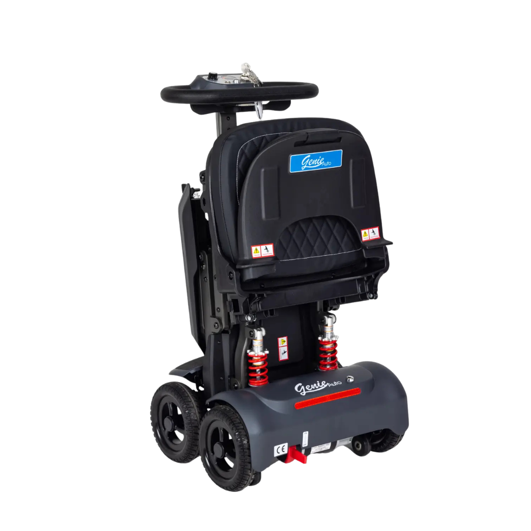 The Monarch Genie Auto Folding Portable Scooter is shown upright and folded for storage or travel. It’s black with four wheels, red suspension springs, and a padded seat featuring the “Genie” logo—ideal for portable, easy mobility.