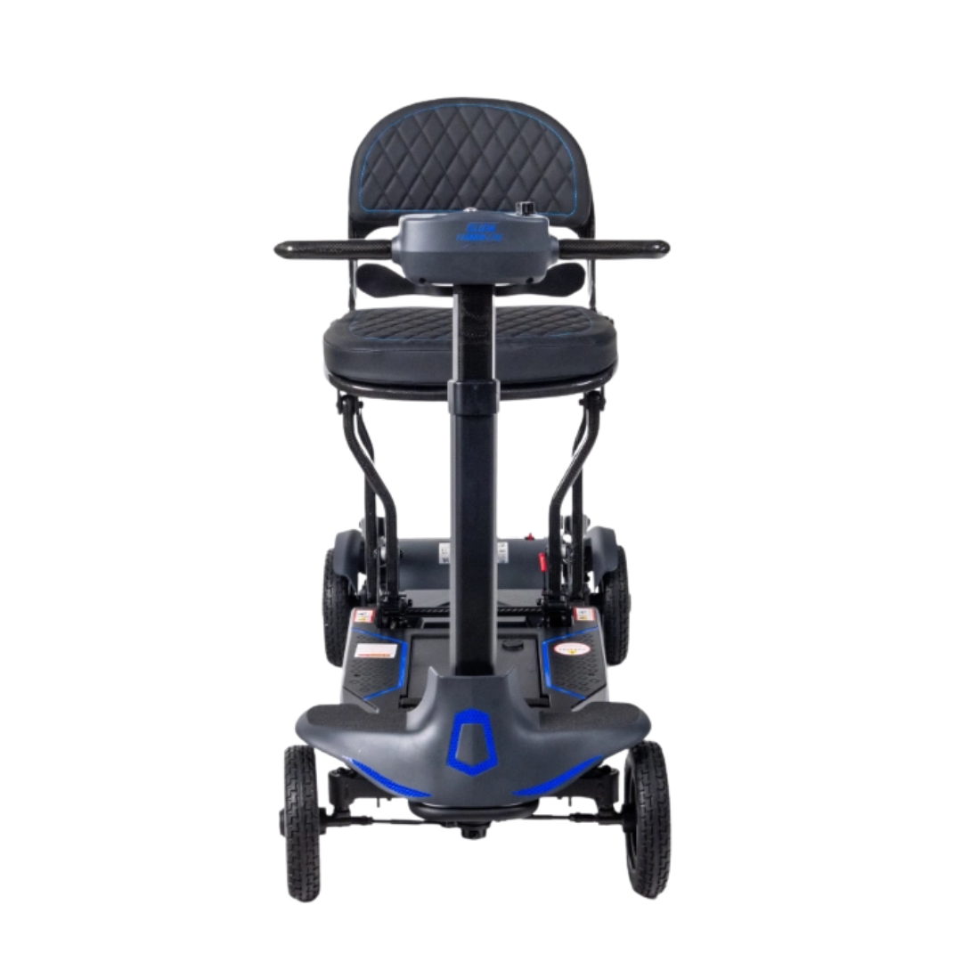 Front view of the Monarch Supa Carbon Lite, an ultra-lightweight carbon-fiber scooter in black with blue accents, padded seat and backrest, armrests, and three wheels.