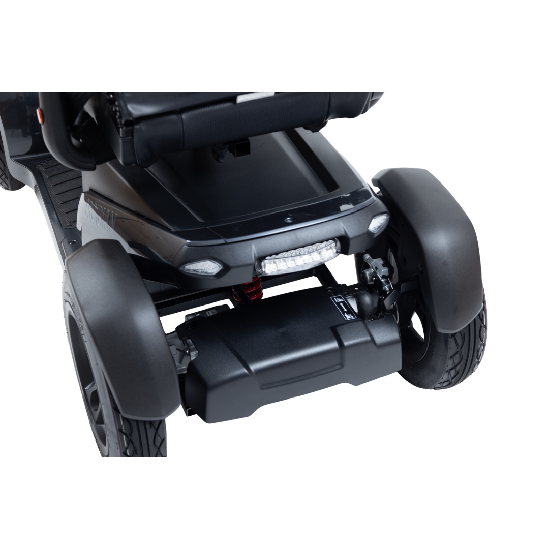 Close-up of the front section of the Monarch Obsidian HD Outdoor Mobility Scooter in black, highlighting wheels, fenders, lights, and footrest against a white background—perfect for presenting specifications or warranty info in product videos.