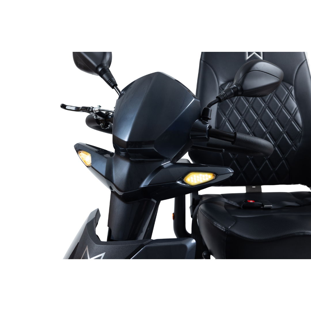 Close-up of the Monarch Obsidian HD Outdoor Mobility Scooter’s front, showing its black finish, illuminated turn signals, rearview mirrors, and quilted seat—ideal for viewers interested in features or warranty specifics.