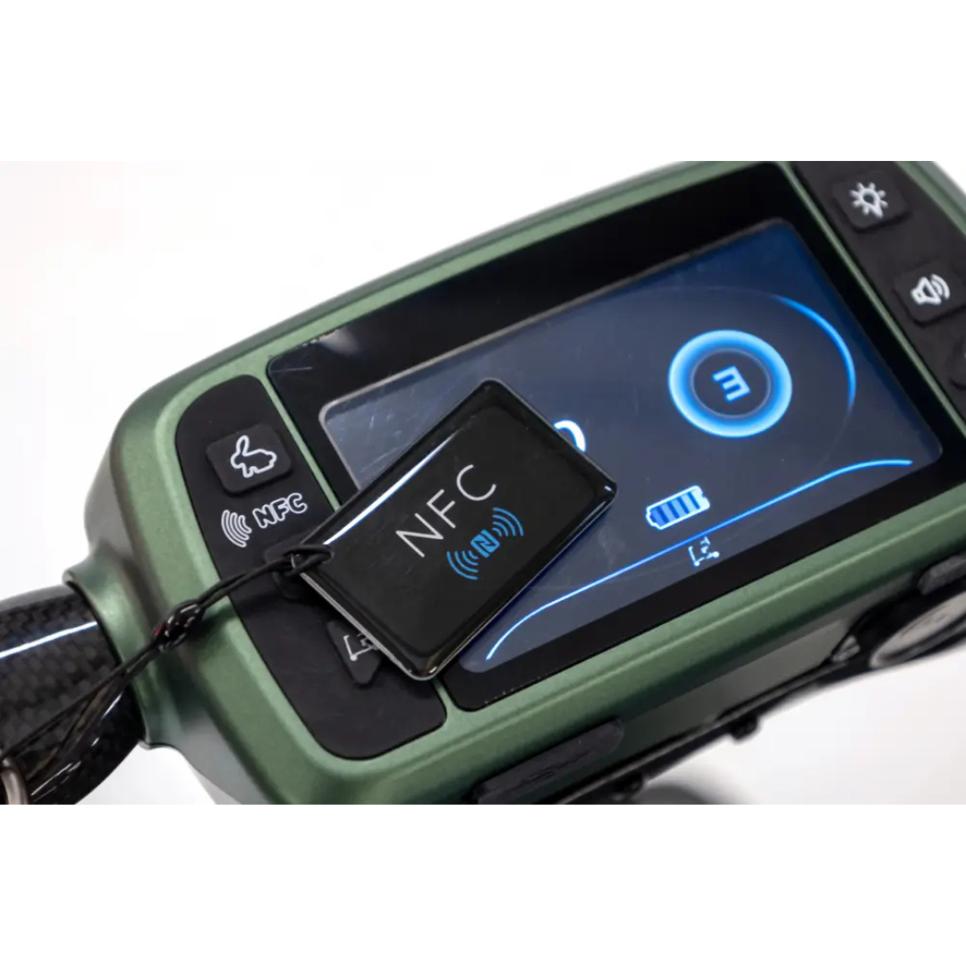 A close-up of the Monarch Smarti Plus Ultra-Lite Auto Folding Scooter’s electronic dashboard with a digital display and a black NFC key tag featuring the NFC symbol, plus dashboard buttons and an icon display screen.