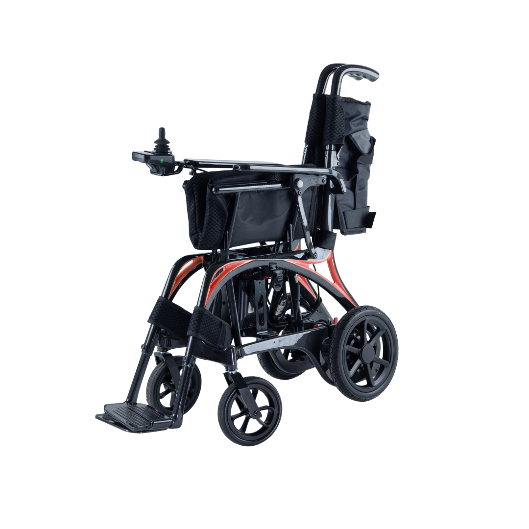 The Monarch Ezi Fold Carbon Portable Power Wheelchair features black upholstery, a foldable lightweight frame, armrest joystick control, rear storage pouch, and footrests, shown in the photo against a white background.