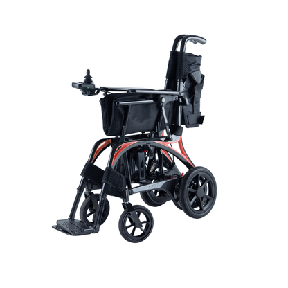 The Monarch Ezi Fold Carbon Portable Power Wheelchair features black upholstery, a foldable lightweight frame, armrest joystick control, rear storage pouch, and footrests, shown in the photo against a white background.