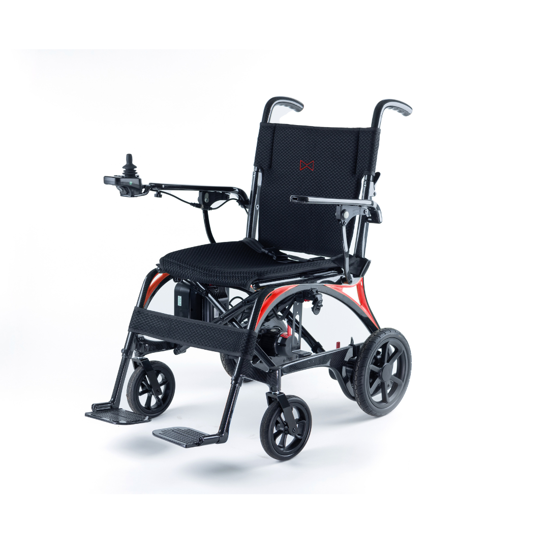 The Monarch Ezi Fold Carbon Portable Power Wheelchair features a sleek red and black frame, black mesh seat, elevated armrests, left-hand joystick, sturdy footrests, and modern lightweight design—shown against a white background.