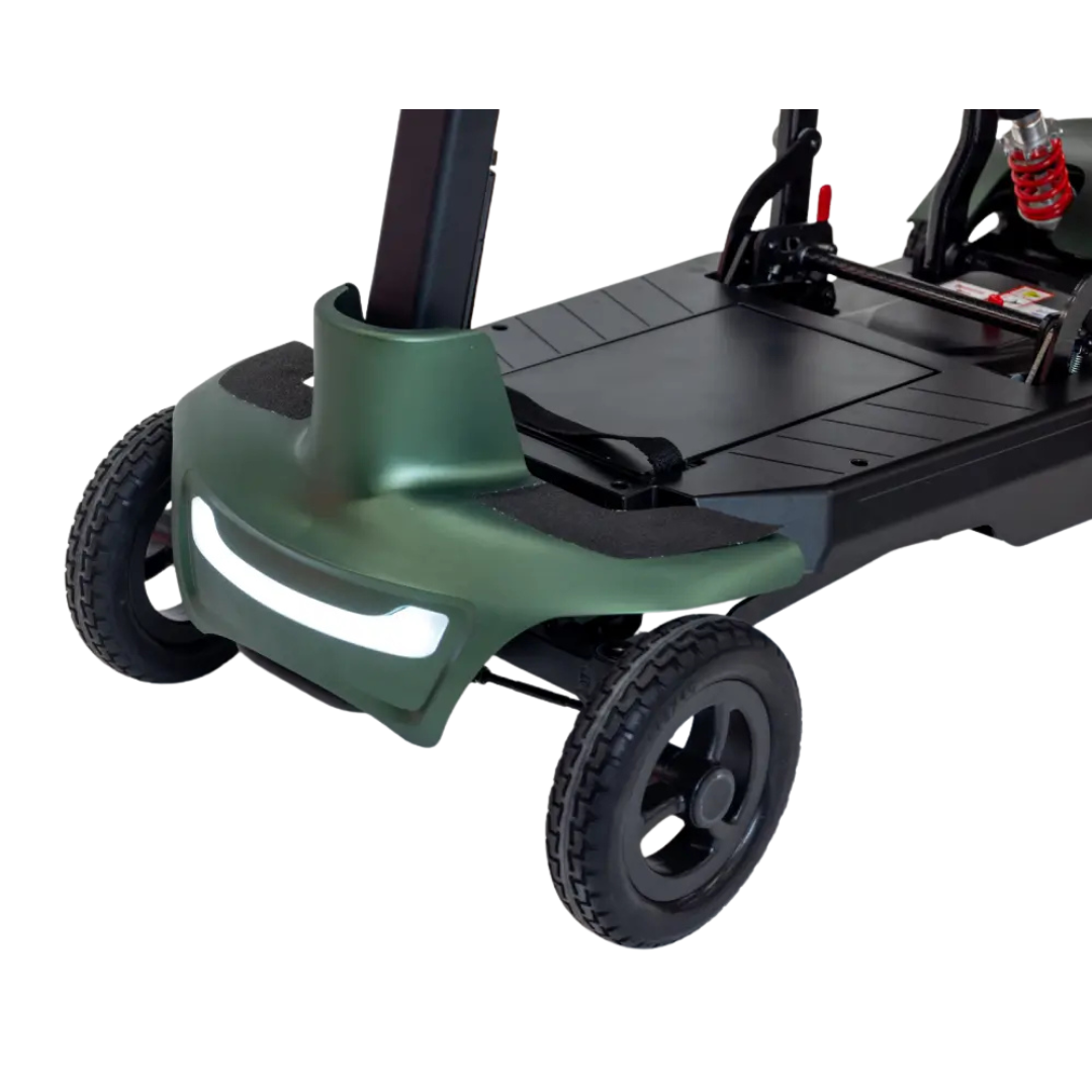 Close-up view of the Monarch Smarti Plus Ultra-Lite Auto Folding Scooter's front, featuring two wheels, green bumper, white headlight, and part of the black footrest with visible metal and suspension components.