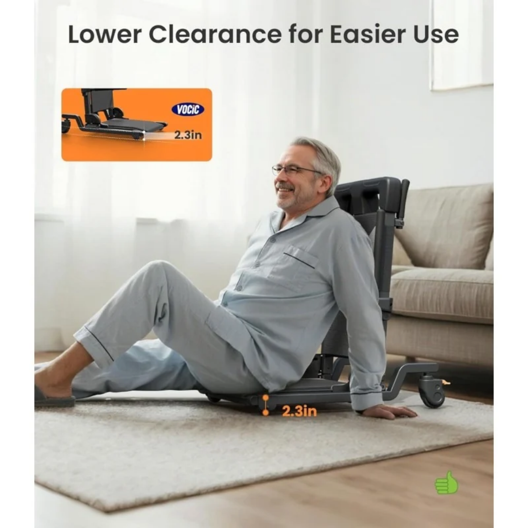 A man in pajamas sits on a VOCIC AX35 Movable Electric Chair & Floor Lift with 4 wheels and a 2.3-inch low base.