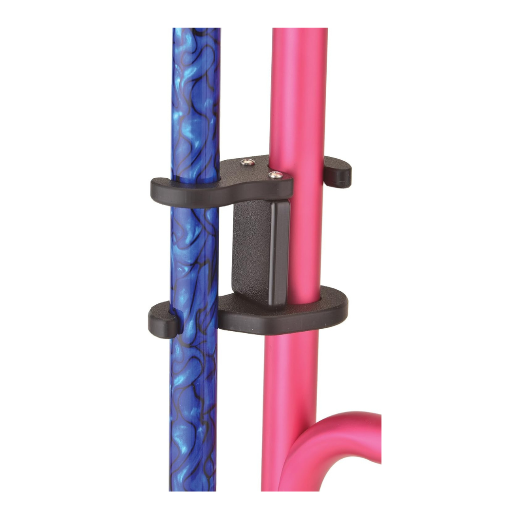 Close-up of the NOVA Medical Cane Holder for Rollators and Folding Walkers, shown in black plastic securing a blue textured pole to a pink metal pole against a white background.
