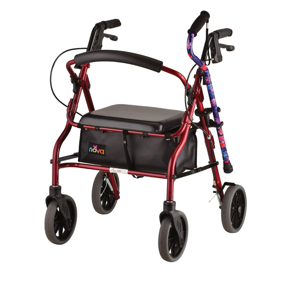 A red four-wheeled walker with black handles, a cushioned seat, a storage pouch, and a floral cane secured with the NOVA Medical Cane Holder for Rollators and Folding Walkers.