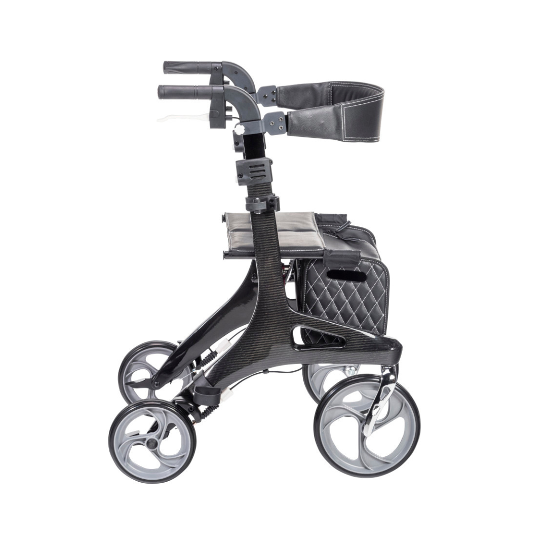 The Drive Nitro® Elite CF Carbon Fiber Rollator is a modern black and gray ultra-lightweight rollator with a cushioned seat, padded backrest, storage bag, and ergonomic handles, shown from the side against a white background.