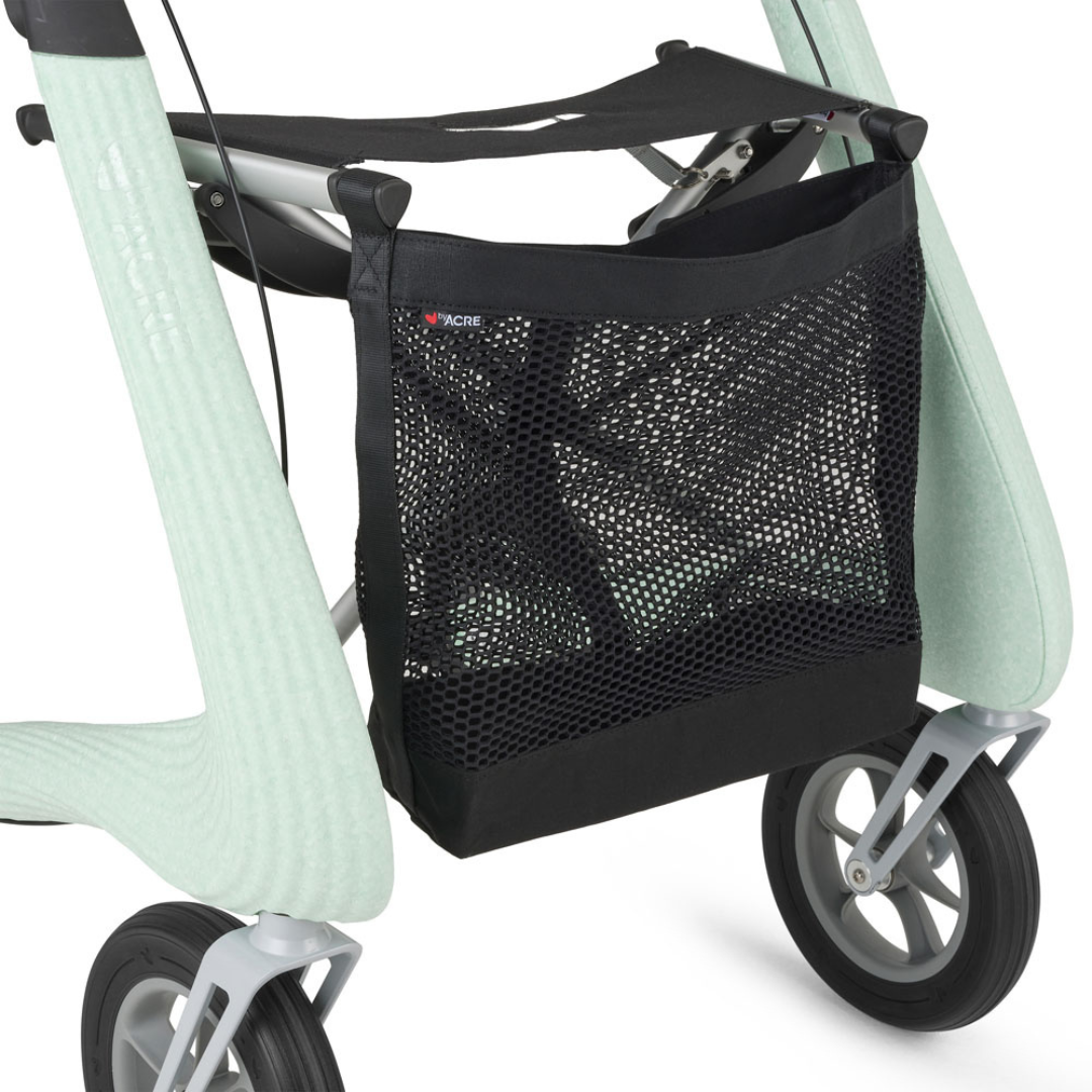 A close-up of a black mesh storage bag attached to the frame of a light green byACRE Nordic Pioneer Lightweight Folding Rollator - Only 13 lbs, showing two gray wheels.