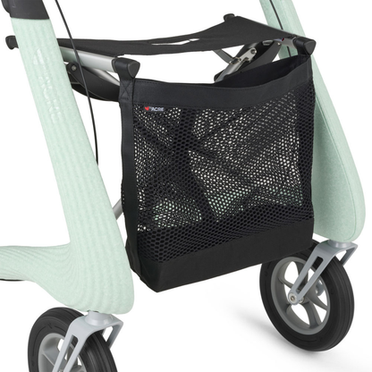 A close-up of a black mesh storage bag attached to the frame of a light green byACRE Nordic Pioneer Lightweight Folding Rollator - Only 13 lbs, showing two gray wheels.