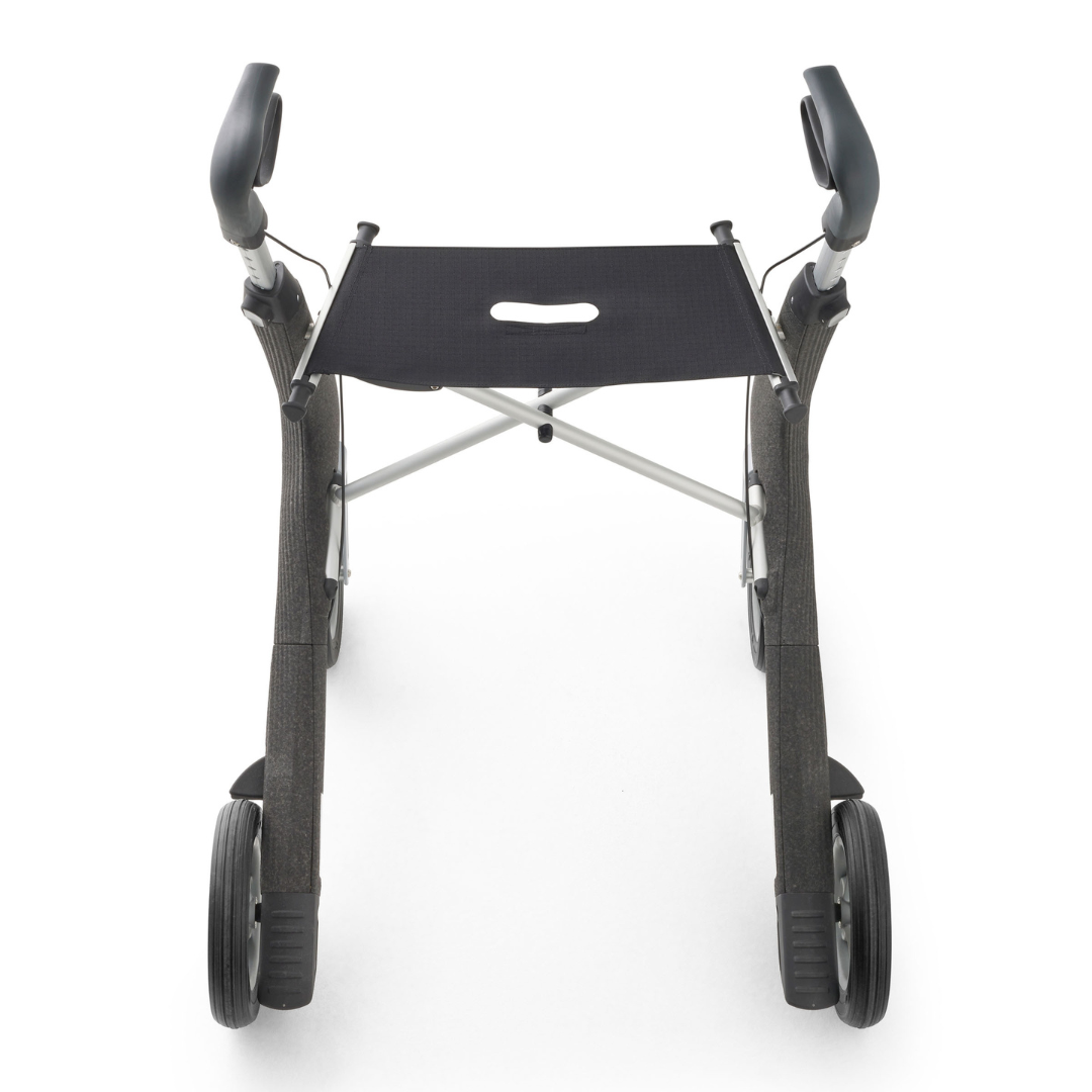 A top-down view of the byACRE Nordic Pioneer Lightweight Folding Rollator—only 13 lbs—shows its sleek black and silver frame, four wheels, comfy hand grips, and built-in seat set against a white background.