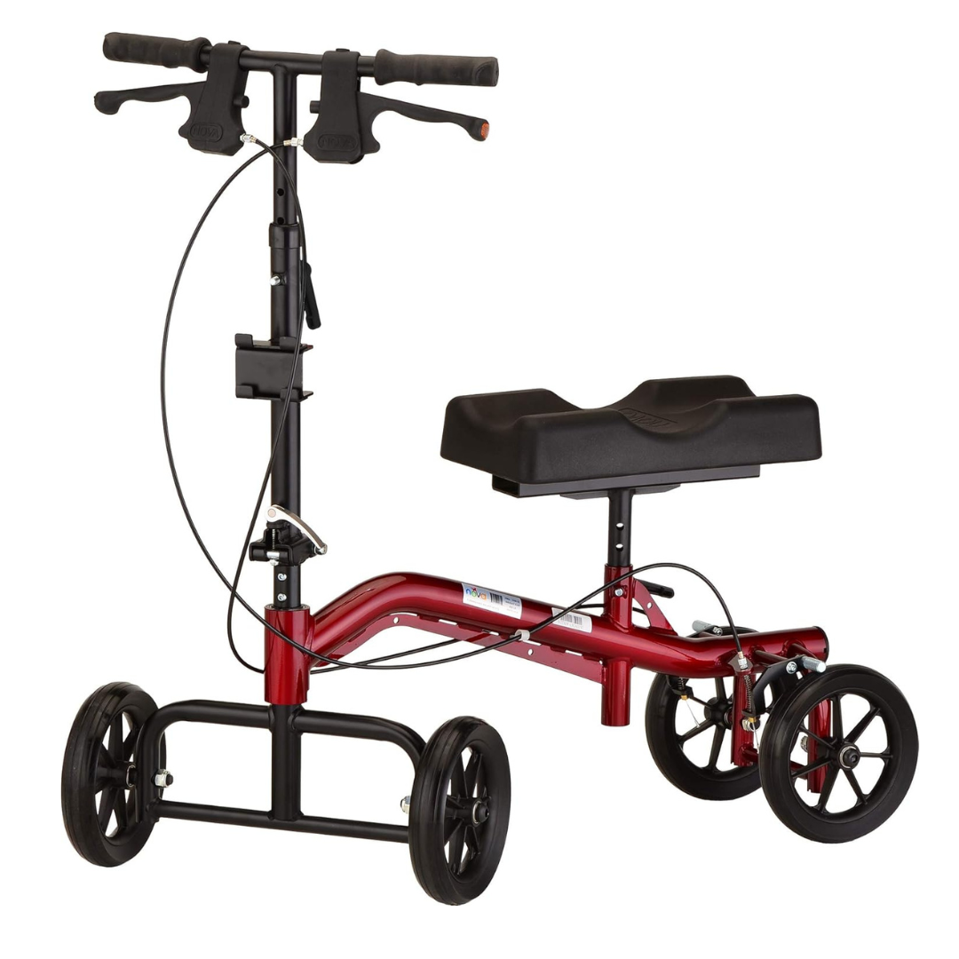 The Nova Medical Turning Folding Knee Walker is a red scooter with black handlebars and a cushioned knee platform. It includes four black wheels, a sturdy frame, and is height adjustable for non-weight-bearing support ideal for mobility and injury recovery.
