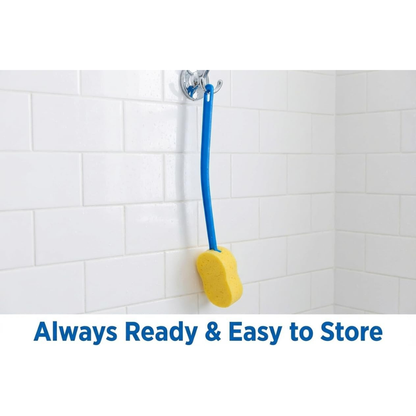 A Nova 23” Extra Long Bath & Back Sponge Brush (2 Pack) with a yellow sponge and blue handle hangs from a suction cup on a white tiled shower wall. Text below reads, Always Ready & Easy to Store.