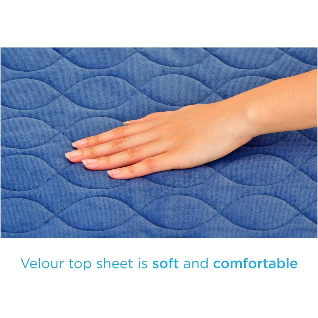 A hand touches the blue quilted surface of the Nova Ultra Reusable Waterproof Underpad For Chairs (21" x 22"), showcasing its soft, velour top sheet and cozy, comfortable feel. Perfect protection with a stylish wavy pattern in blue.