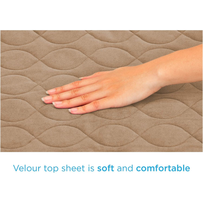 A hand gently touches the quilted, light brown velour surface of the Nova Ultra Reusable Waterproof Underpad For Chairs (21" x 22"). Text reads: Velour top sheet is soft and comfortable—perfect for reusable bed or chair pads.