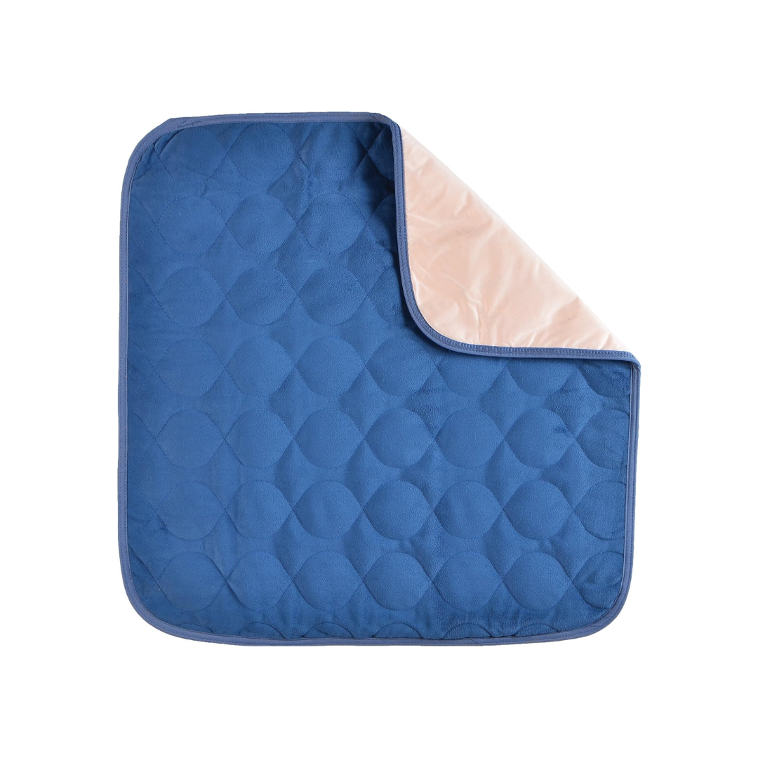 The Nova Ultra Reusable Waterproof Underpad For Chairs (21" x 22") is square, quilted, and features a blue top with a light beige underside. One corner is flipped to reveal both sides, all shown on a white background.