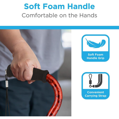 Close-up of a person holding a Nova Designer Offset Walking Cane with a red shaft and soft black foam handle. Text highlights soft foam handle for comfort, grip icon, and carrying strap—perfect among offset walking canes.