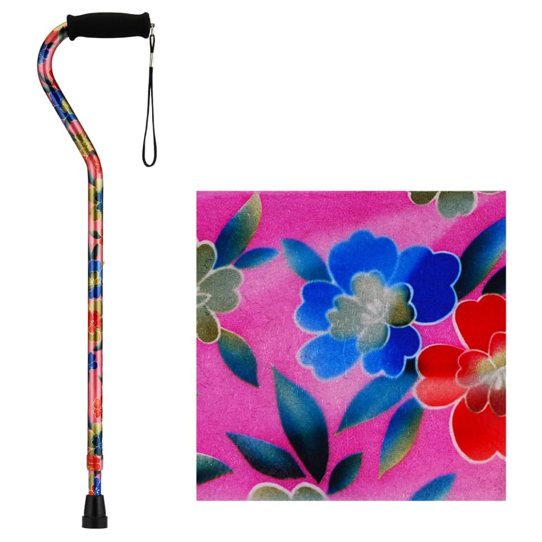 The Nova Designer Offset Walking Cane features a curved handle, wrist strap, and a vibrant floral pattern in red, blue, and green on a pink background. A close-up highlights the cane’s colorful design.