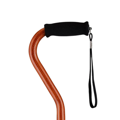 A close-up of the handle of a Nova Designer Offset Walking Cane, featuring a black foam grip and attached black wrist strap, set against a plain white background.