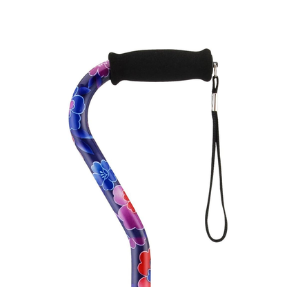 A close-up of a Nova Designer Offset Walking Cane shows its black foam handle, wrist strap, and vibrant floral patterned shaft, all set against a white background.
