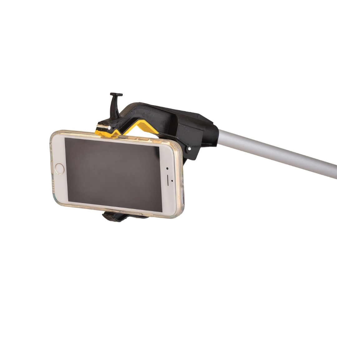 A Nova Medical Dragon Reacher holds a smartphone in its clamp—like a selfie stick or ergonomic reacher—with the phone's screen facing outward.