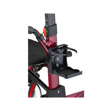 Close-up of the Nova Folding Cup Holder for Dragon and Monarch Rollators attached to the red frame, with parts of a black seat and handlebar also visible.