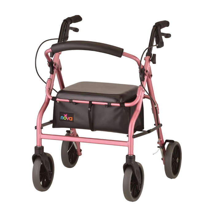 The Nova Medical Zoom Rollator in pink features hand brakes, a cushioned seat with adjustable height, and a black storage pouch attached to the front frame. Available in 4 size options.