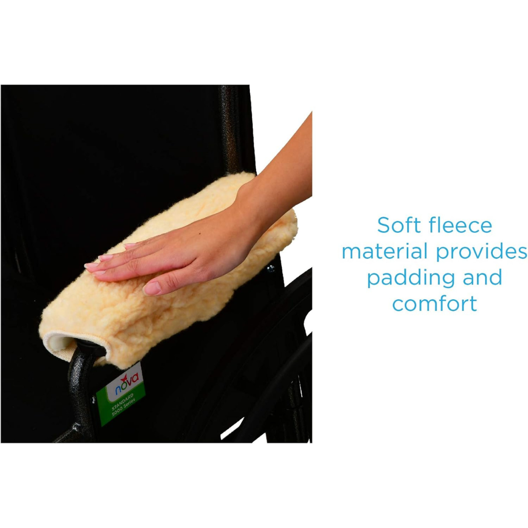 A hand rests on a cream Nova Sheepskin Fleece Armrest Cover for wheelchairs, highlighting its soft fleece material that adds comfort and padding.