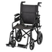 The Nova Medical Lightweight Transport Chair - 12” Rear Wheels boasts a foldable design in sleek black. It includes armrests, a safety belt, footrests, and locking handbrakes. Its large rear wheels and small front ones ensure effortless all-terrain mobility for secure transport.