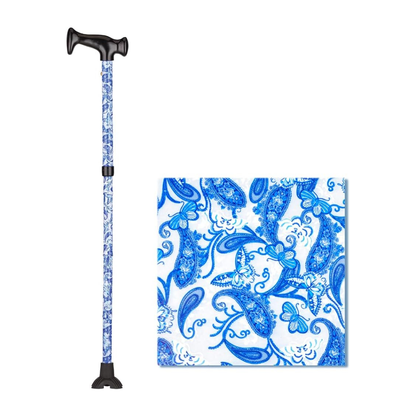 The Nova Folding Walking Cane features a wood grip handle and quad tip, decorated with a blue and white paisley floral pattern. An inset highlights the detailed blue paisley and butterfly design.