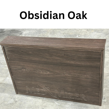 A Med-Mizer ActiveCare Rotating Hospital Bed panel with a dark brown wood grain finish labeled "Obsidian Oak" rests on a concrete floor, ideal for adjustable or home care beds.