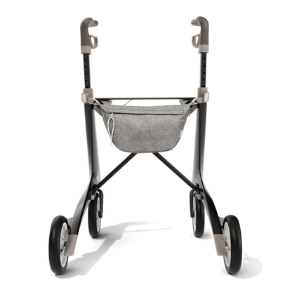 The Organizer Bag for ByAcre Carbon Fiber Rollators, attached to a lightweight four-wheeled walker with grey handles, is shown from the front against a white background—perfect for practical mobility storage.