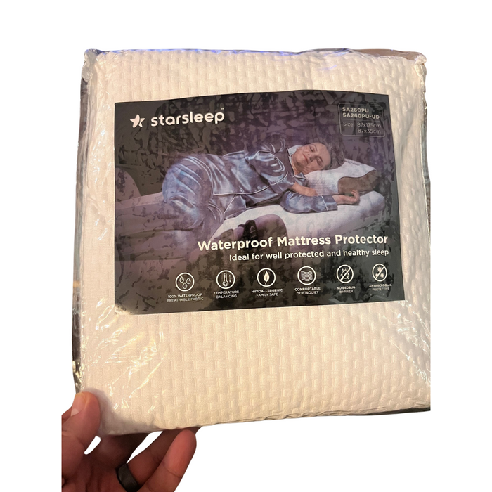 A hand holds a packaged waterproof mattress protector labeled Starsleep Orin Bed Sheets and Protectors, featuring an image of someone sleeping peacefully. Its perfect for healthy sleep when paired with 100% cotton sheets.