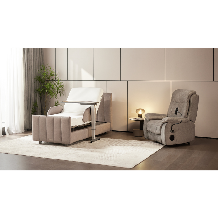 A modern living room includes a light gray reclining chair, matching armchair, and a small table with decor. A large plant by the window with sheer curtains adds charm. Nearby, the Starsleep Orin Rotating Full Electric Lift Assist Bed with Heat & Massage ensures relaxation on the soft rug below.