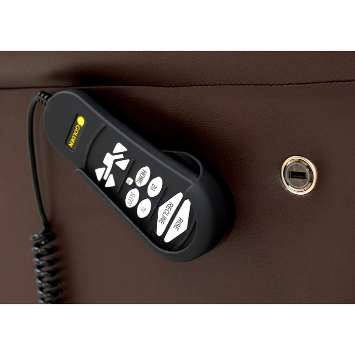 A black and white remote control with various ZG+ functions is attached to the side of a brown leather Golden Tech PR510 MaxiComfort Cloud Recliner, featuring a coiled cord and a USB port on the leather surface.