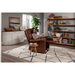 In a modern living room, a woman relaxes in the Golden Tech PR515 Cloud Recliner With Lift Assist, reading a book. A side table holds fruit. A large plant, bookshelf, and white cabinet with decor complement the gray walls and patterned rug.