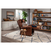 A person relaxes on a Golden Tech PR515 Cloud Recliner with Lift Assist, feet up, enjoying ergonomic support in a cozy living room. They hold a remote as the room features a large bookshelf with decor, white sideboard, potted plant, and modern wavy-lined rug on wooden flooring.