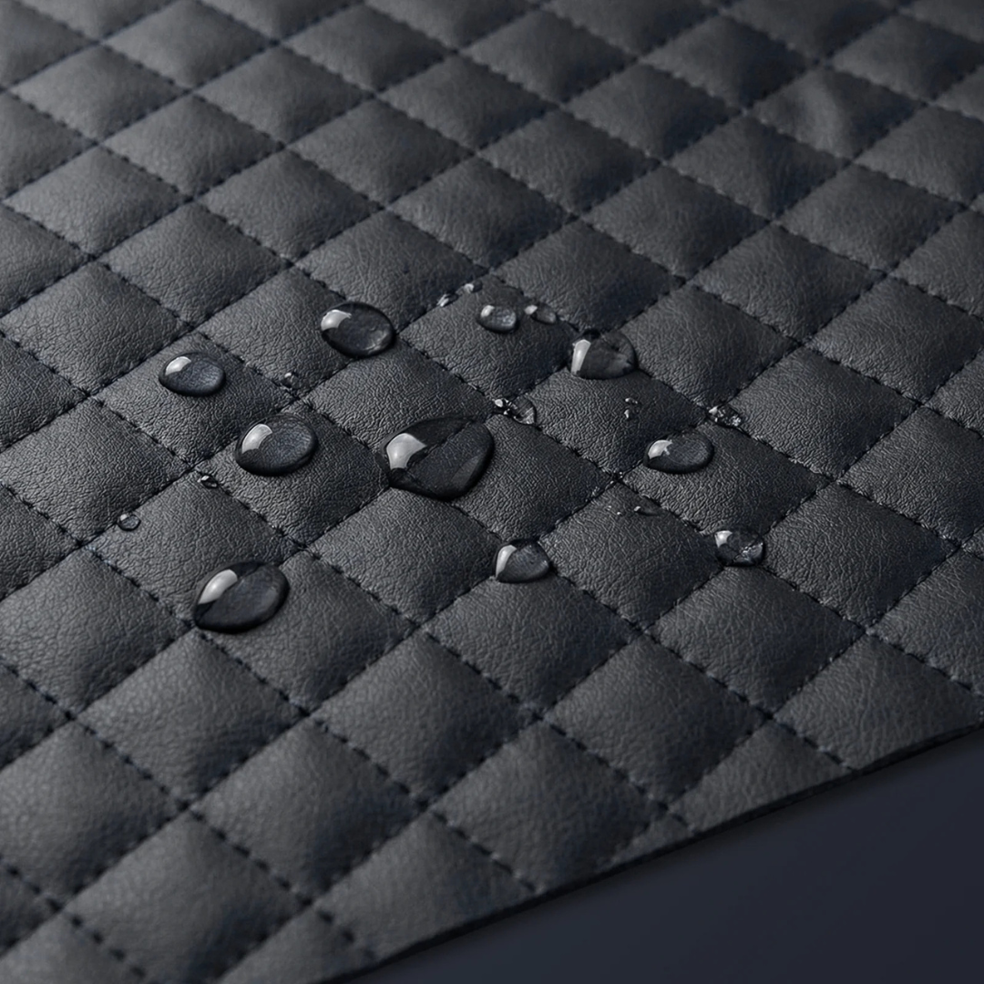 Close-up of the Paiseec Q5 Carbon Fiber Electric Wheelchair’s black, quilted, waterproof material with water droplets beading on the surface—highlighting its excellent water-resistant properties for reliable protection against the elements.