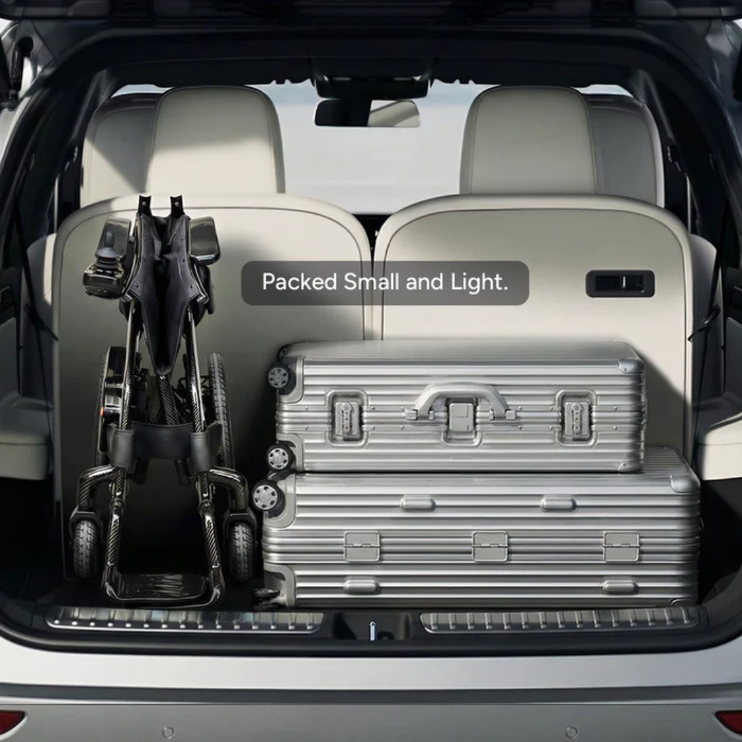 A folded Paiseec Q5 Carbon Fiber Electric Wheelchair and two silver suitcases fit neatly in a car trunk. The text overlay reads “Packed Small and Light,” highlighting the wheelchair’s compact, lightweight design for travel.