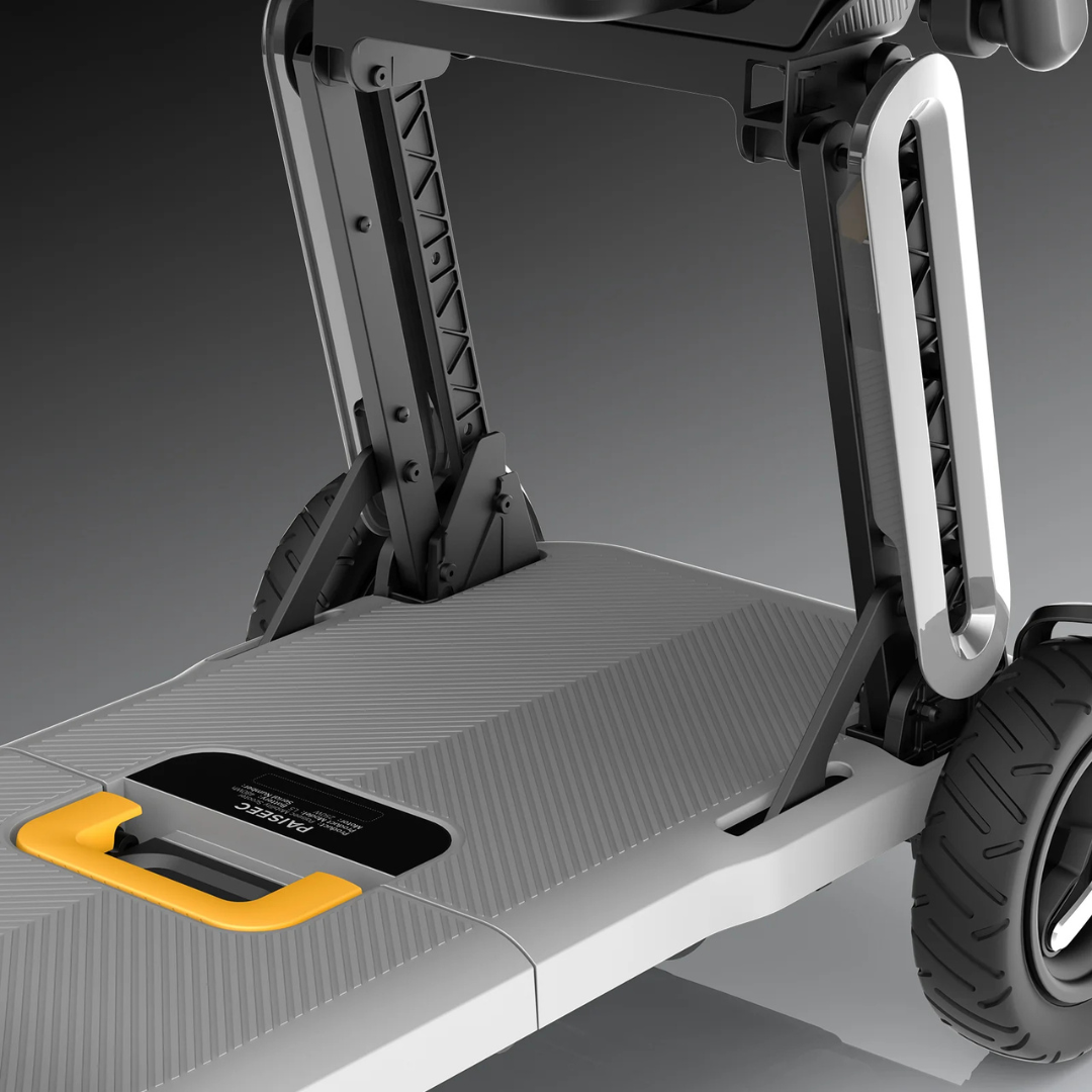 Close-up of the Paiseec L5 Portable Mobility Scooter’s deck, featuring a textured gray footboard, sturdy folding mechanism, large black tire, and yellow handle against a gradient gray background.